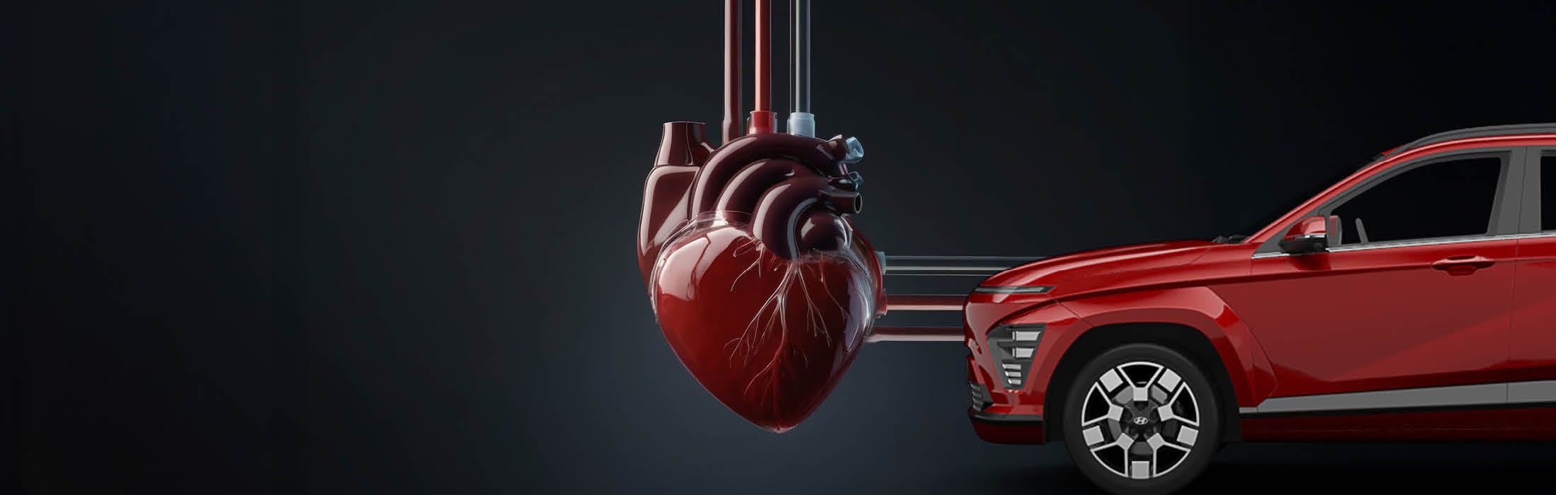 Ein großes, realistisches Herz ist mit mehreren Schläuchen an ein rotes Auto angeschlossen, als würde es das Fahrzeug am Leben halten.